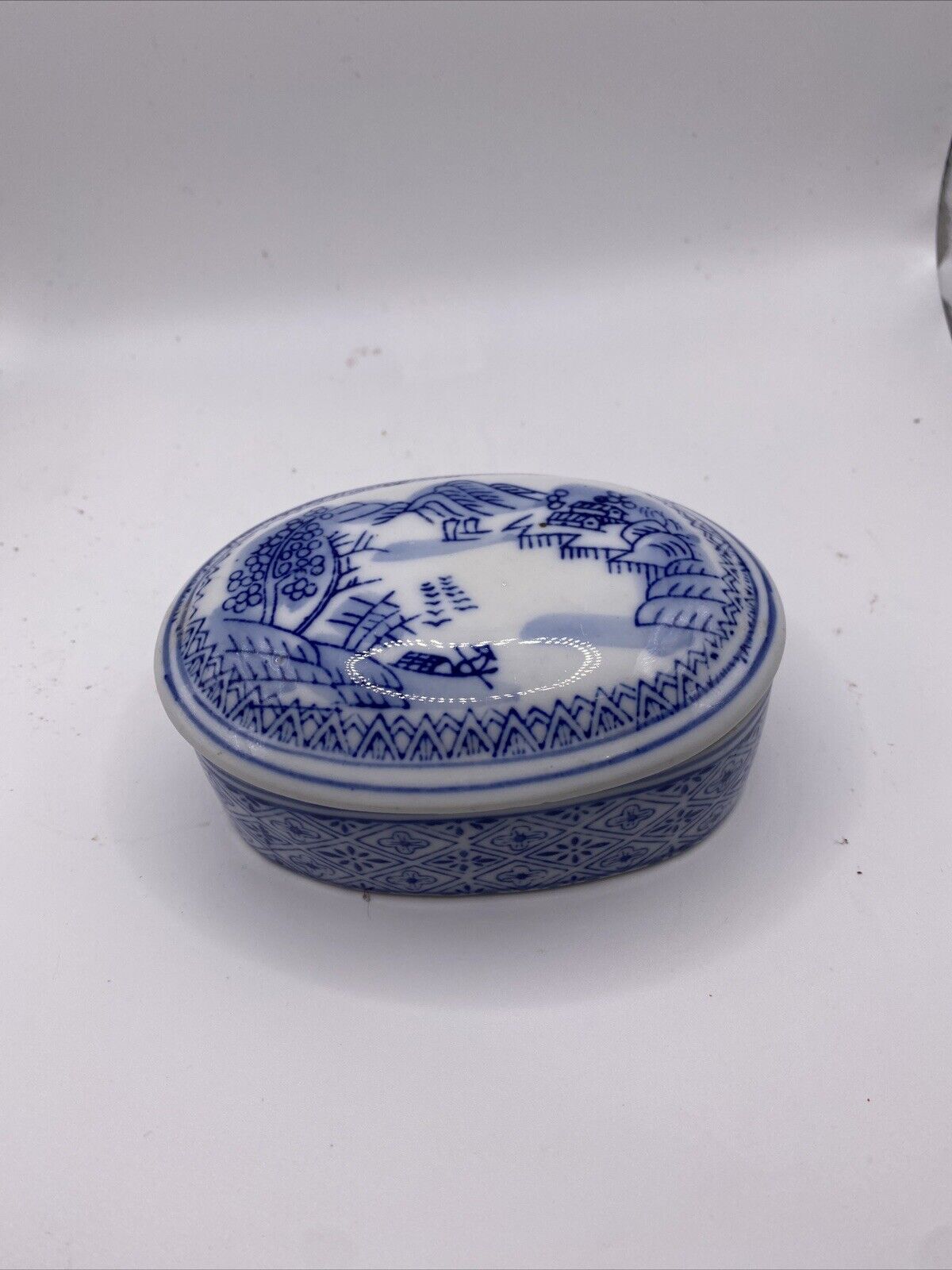 vintage asian porcelain blue white trinket box from China mountains oval lidded 