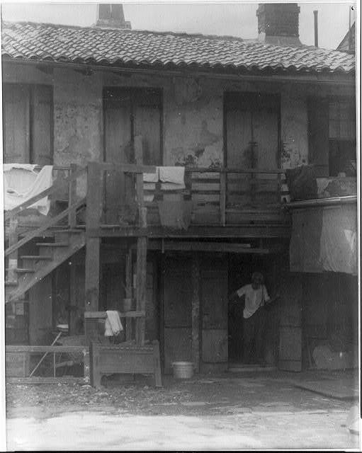 Elderly Negro man in doorway of Spanish tiled roof house,New Orleans,LA,c1925