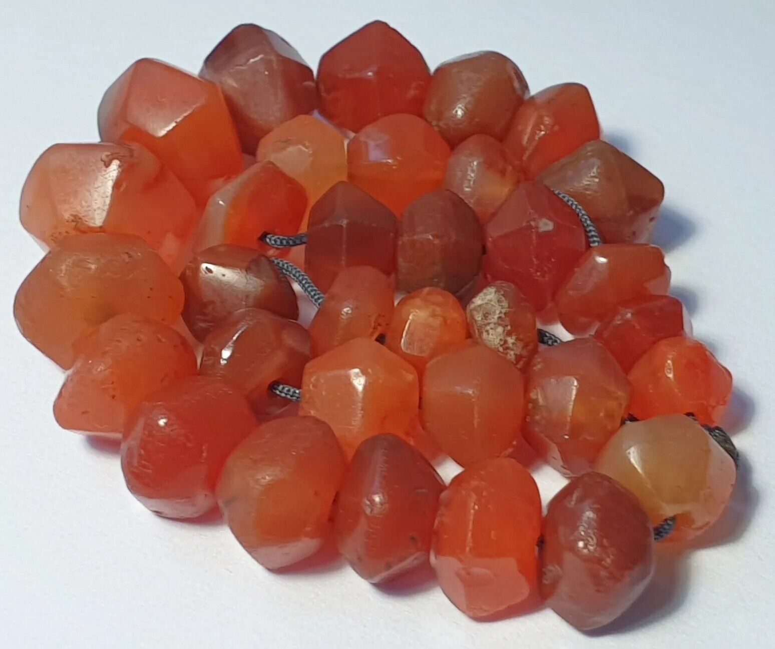 A RARE STRAND OF 33 ANCIENT PERSIAN CARNELIAN FACETED AGATE BEADS (9mm to 15mm)