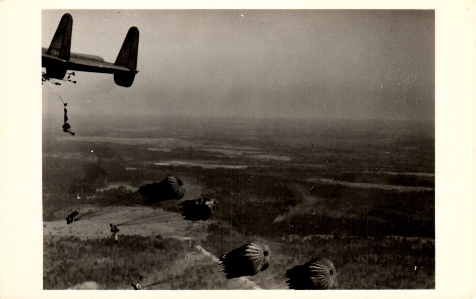 Postcard paratroopers, jumping out of Fairchild XC – 120 Airplane RPPC