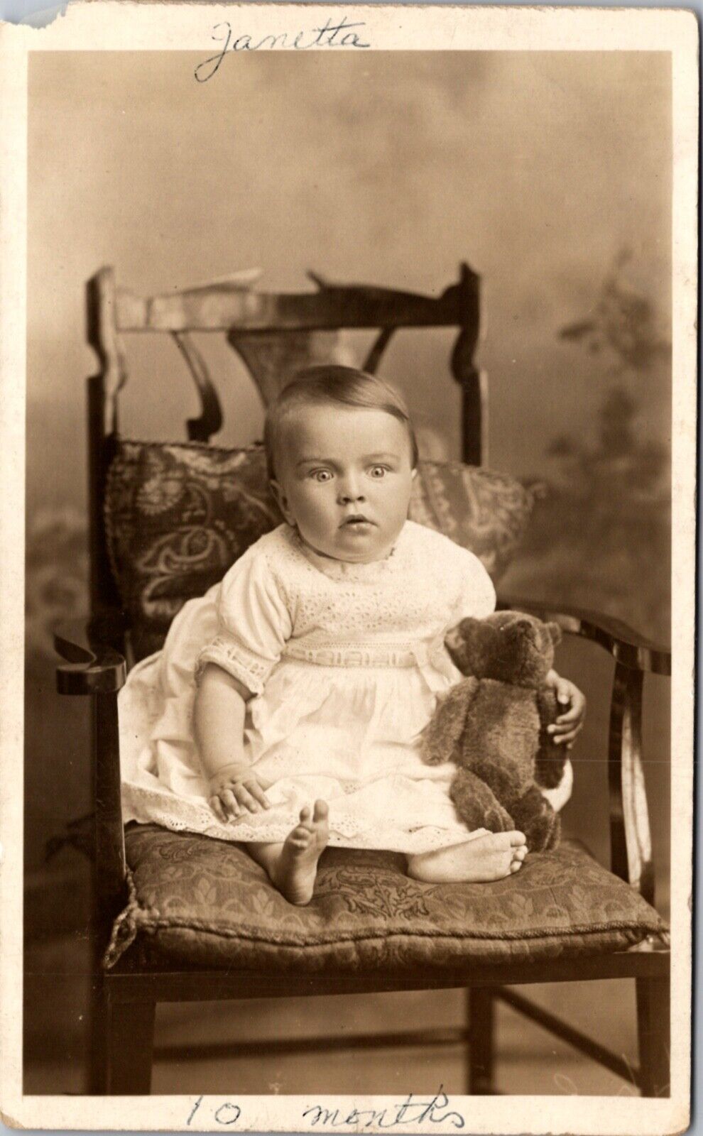 Real Photo Postcard 10 Month Old Baby Sitting In Chair with Teddy Bear