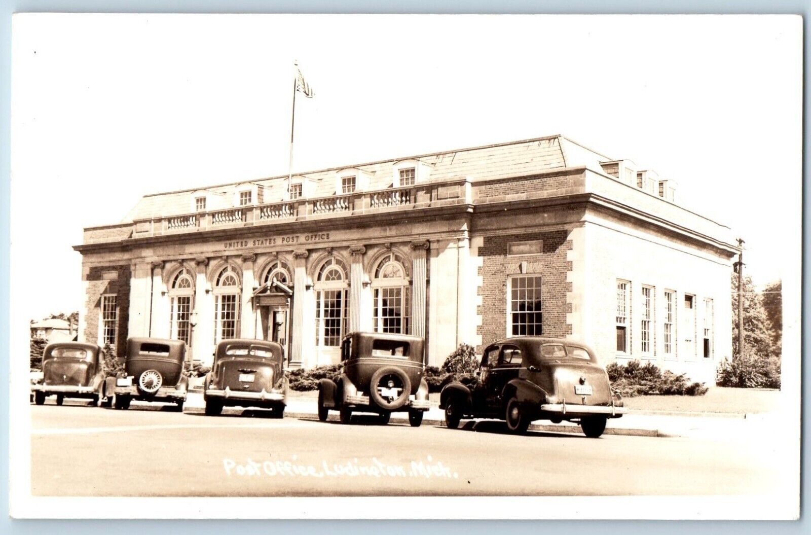 Ludington Michigan MI Postcard RPPC Photo Post Office Building Cars Scene c1940s