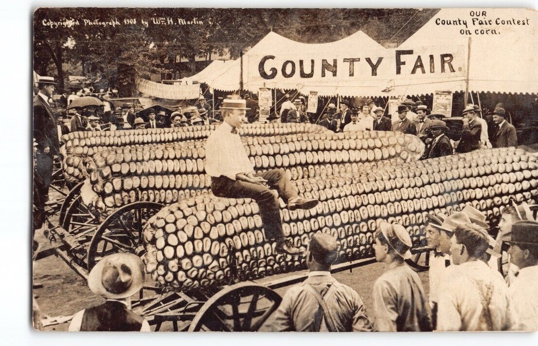WH Martin Exaggeration Man rides Corn County Fair~RPPC Photo Postcard Comic -P3