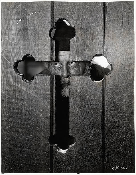 Emil Jannings peers through a cross shaped opening in a door in- 1928 Old Photo