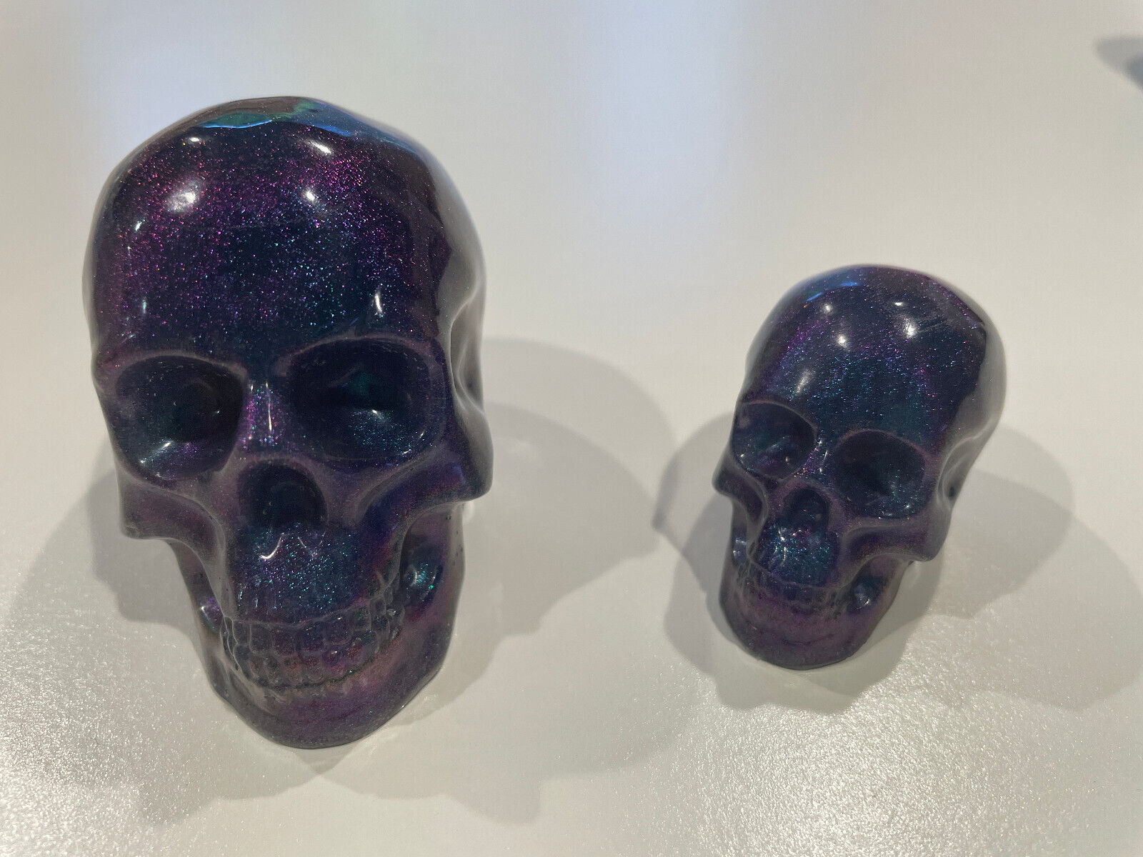 Matched pair Metallic Purple/Blue Sparkle Solid Resin Skulls.  