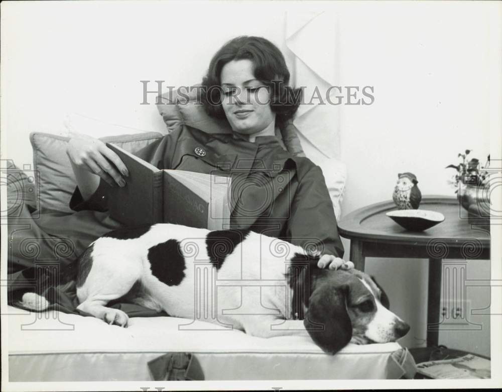 1960 Press Photo Woman and her dog relax together while she reads - nei44999