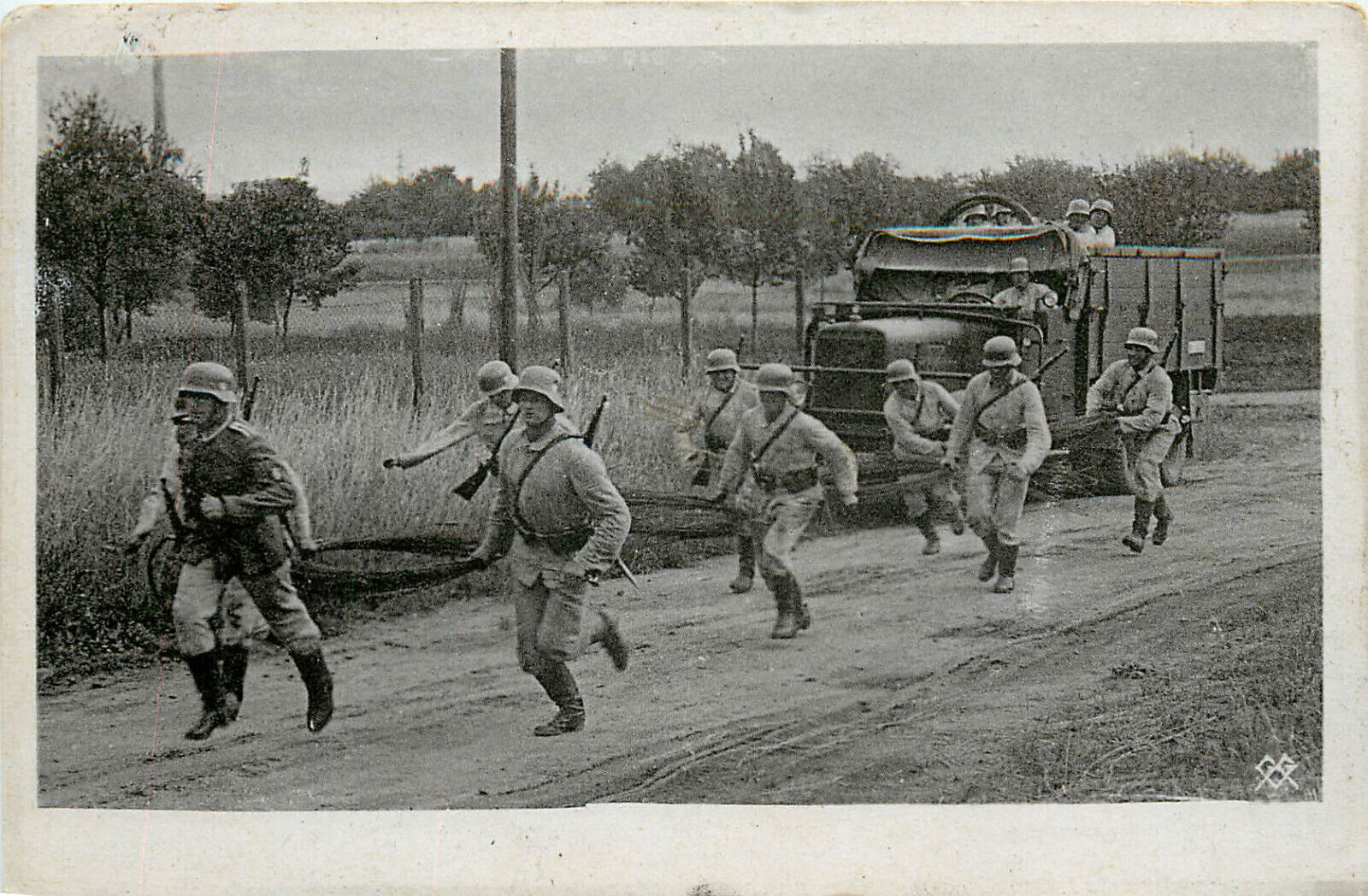 WWII Postcard German Soldiers Run down Road in Front Of Transport Truck