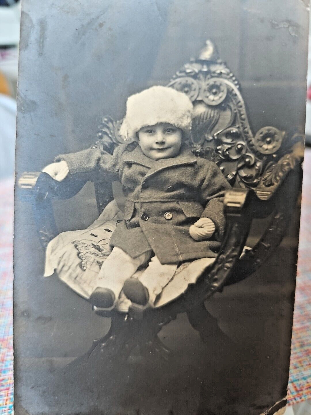Antique Photo portrait of small child sitting on the chair. 1900s.