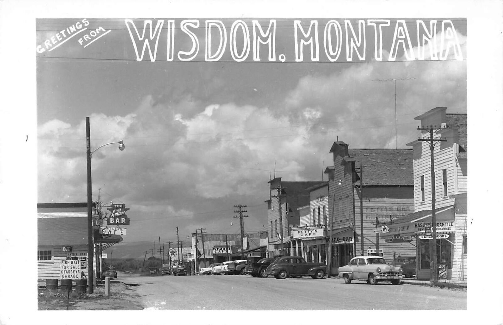 Vintage RPPC Greetings From Wisdom Montana Street Scene Cafe Bar Fish Bait Cars