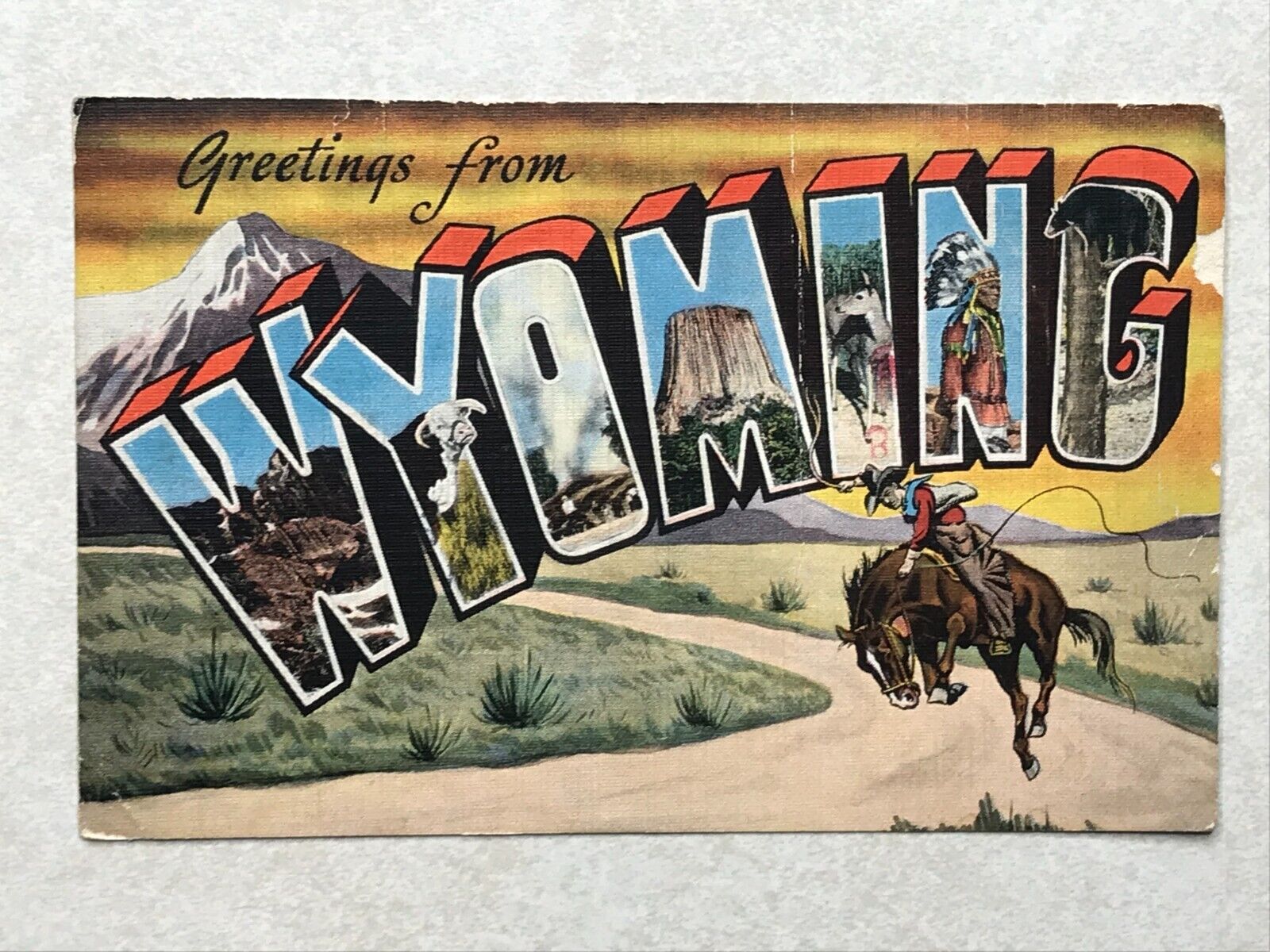 B156 Postcard Greetings from Wyoming cowboy -bad edge