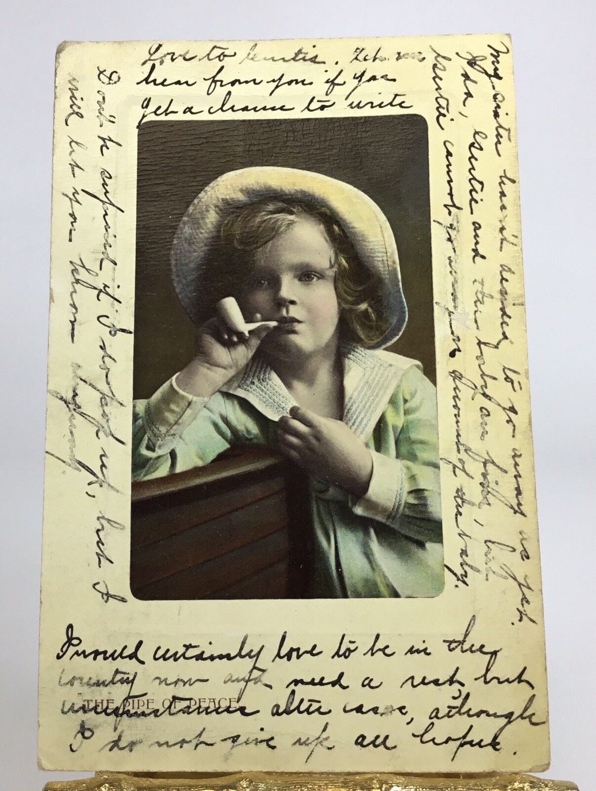 1909 IMAGE OF SMOKING YOUNG ART DECO GIRL WITH Curls & HAT RPPC HAND. COLOR P172