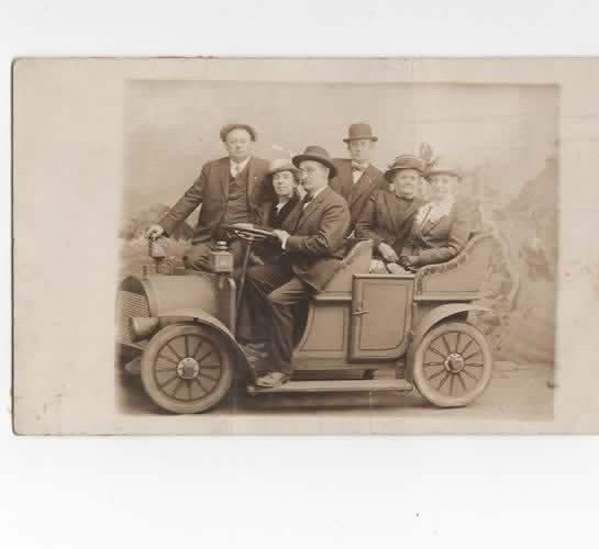 friends posing on a jalopy  c1910  RPPC