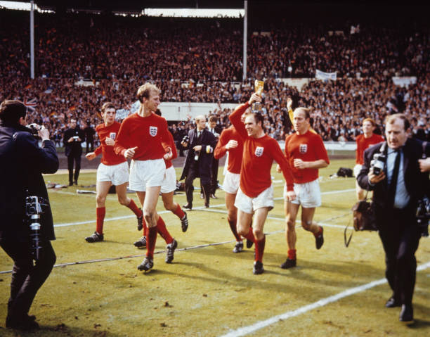 The England team raise the Jules Rimet trophy in the air follow - 1966 Old Photo