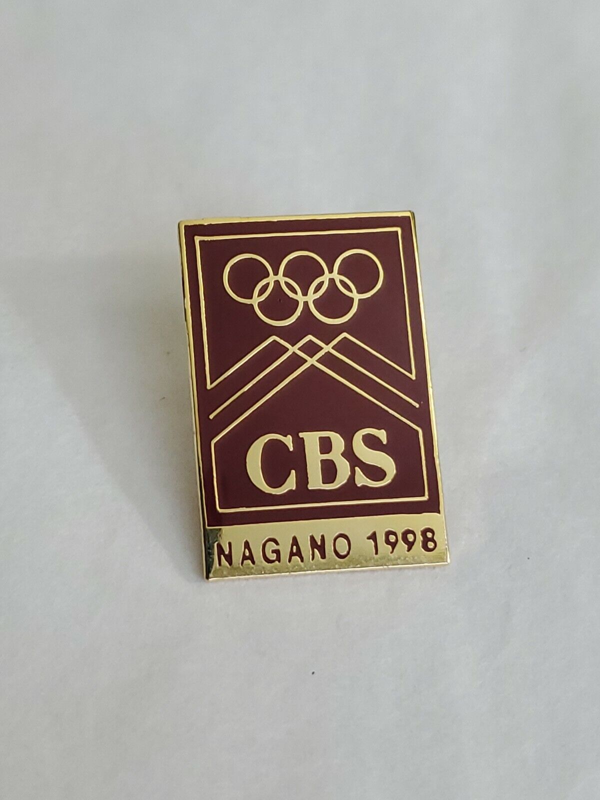 CBS Nagano 1998 Winter Olympic Games Souvenir Pin Maroon And Gold Colored