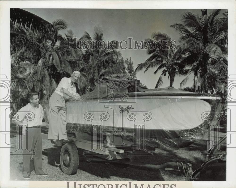 1947 Press Photo Gar Wood Sr. looks over speedboat gift from son Gar Jr., Miami
