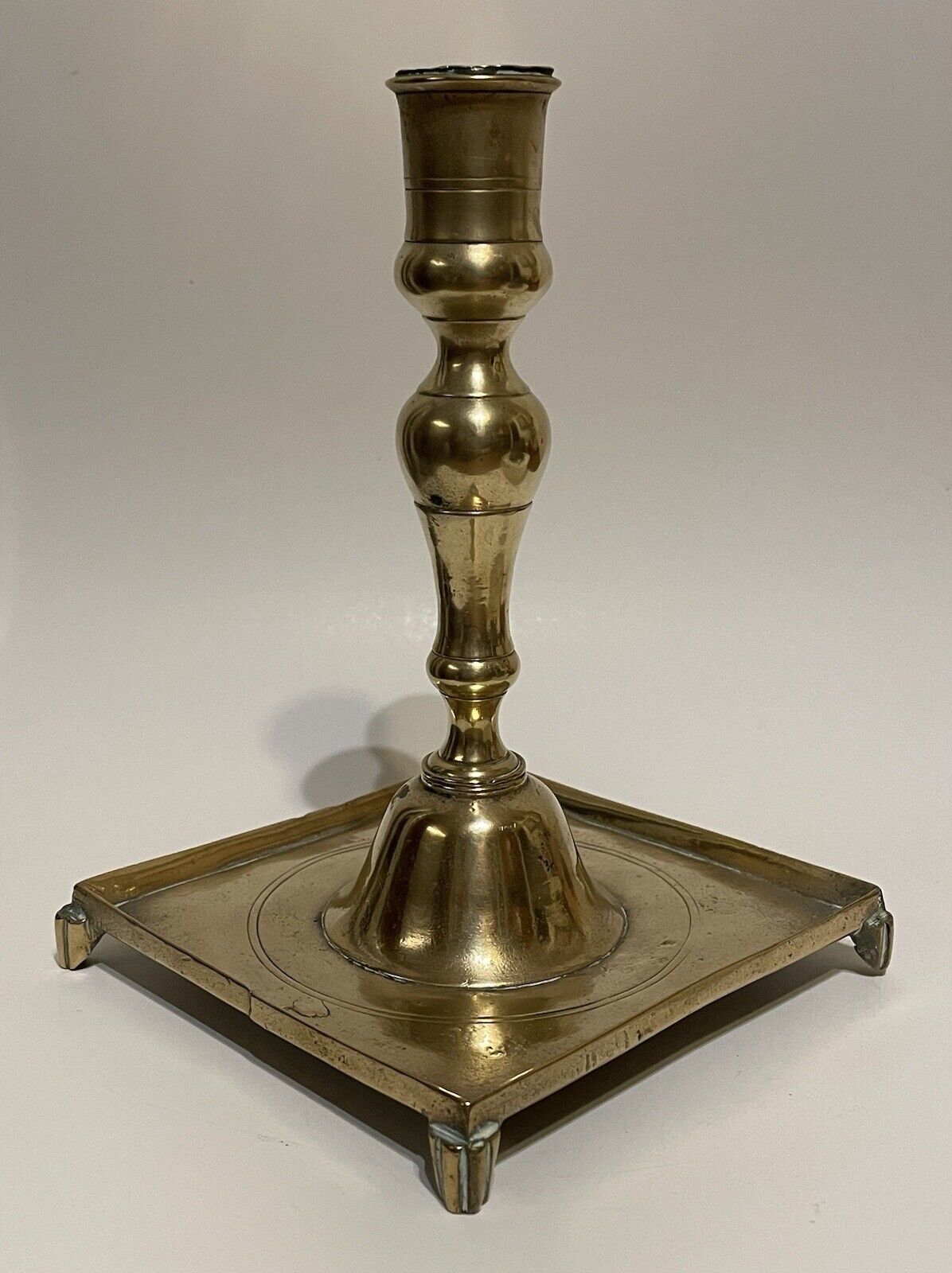 Antique late 17th century brass / copper alloy footed candlestick, ca. 1690