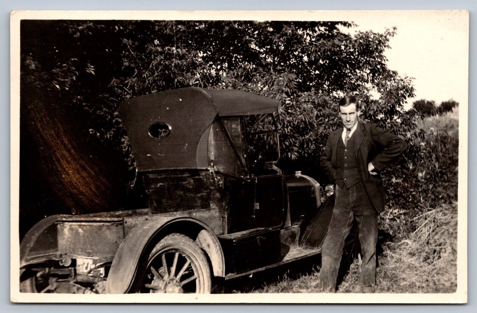 C1905 real photo postcard  man stands next to ANTIQUE AUTOMOBILE
