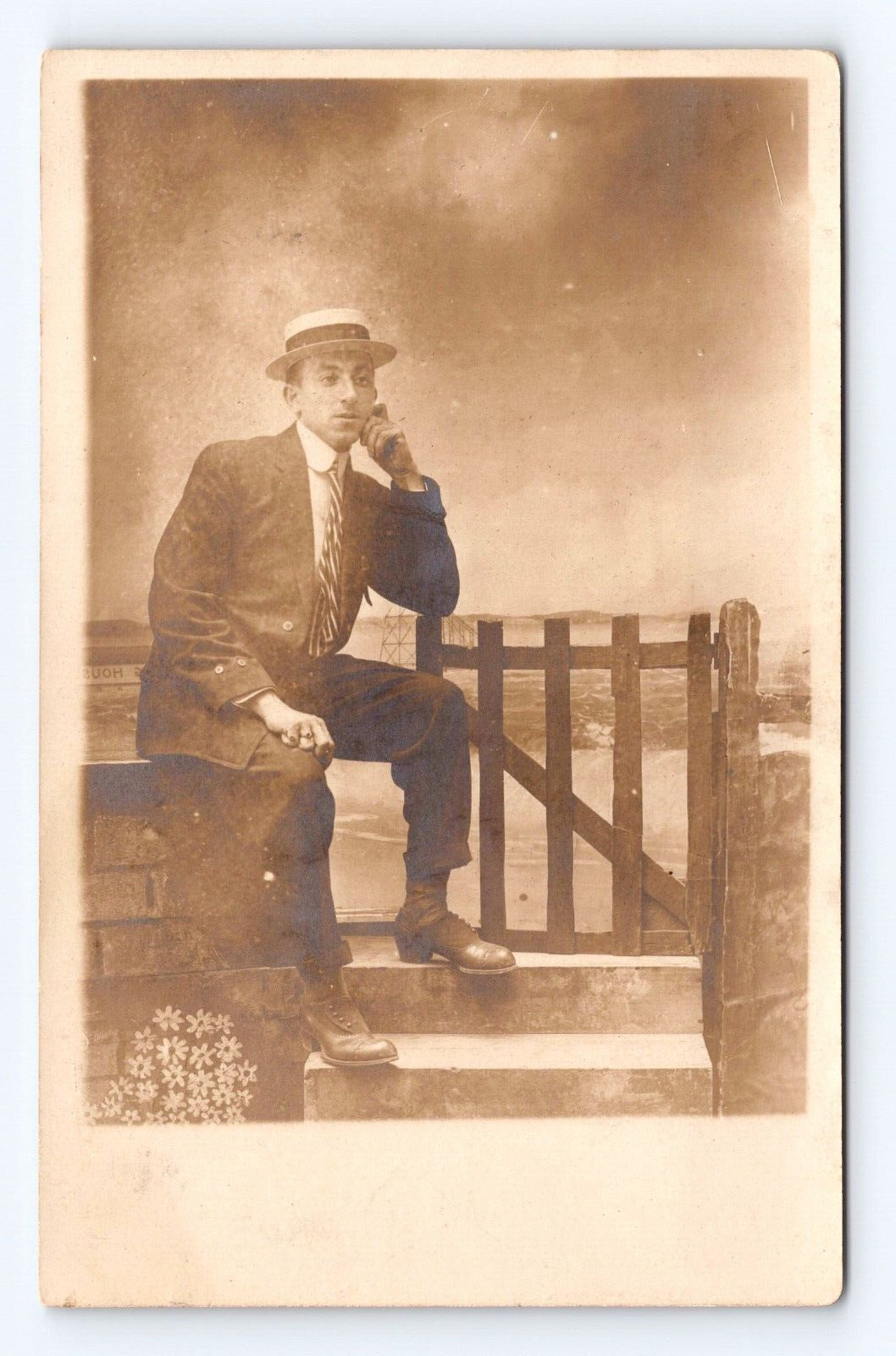 RPPC Photo Postcard Young Man Posing Sitting on Fence Hat Suit Tie c1910-1920