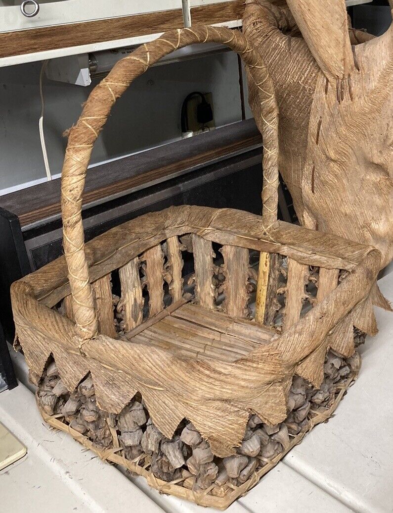 Beautiful antique natural knotted bark, palm frond husks, branch basket