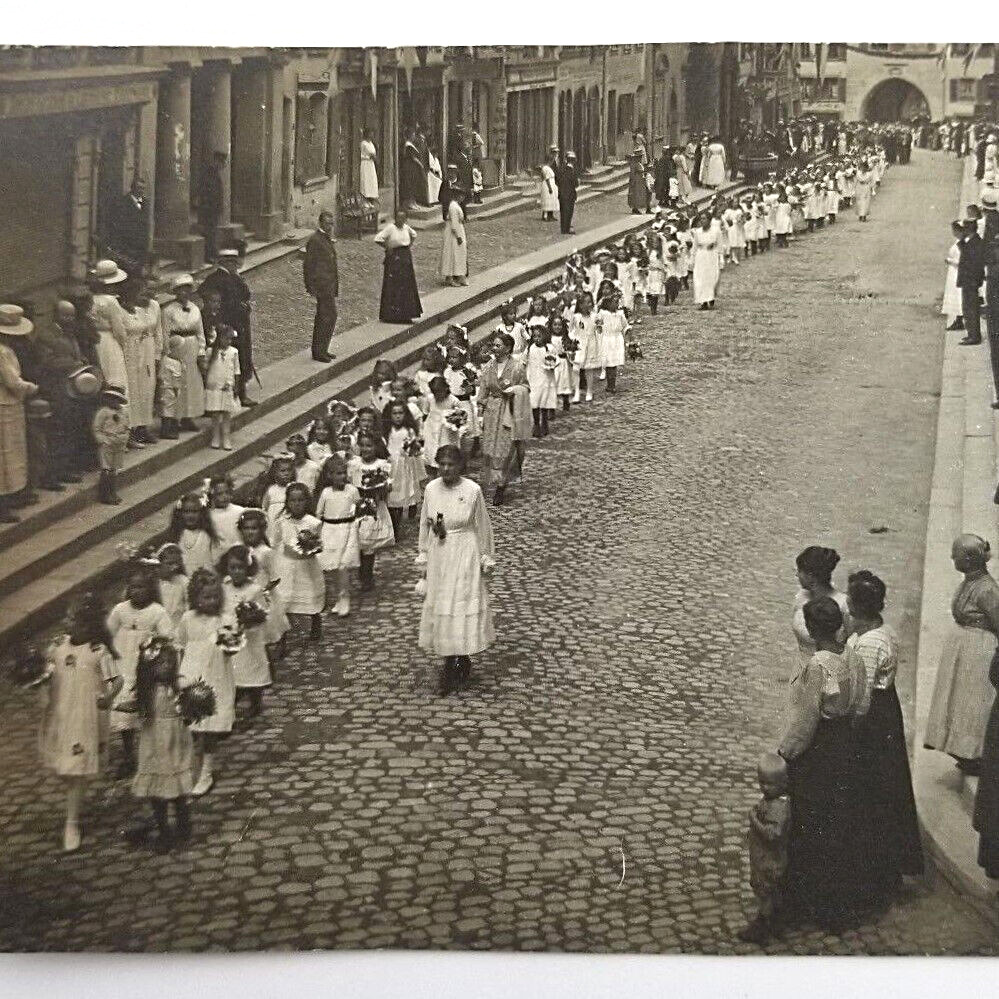 Real Photo Postcard Parade Of Children Walking Down Cobblestone Street 1919