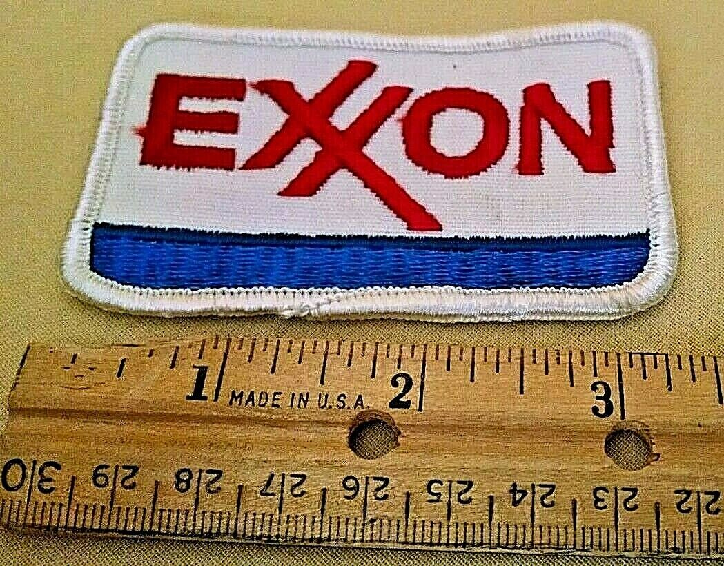 EXXON PATCH RECTANGULAR WHITE TRIM BACKGROUND RED LETTERING THICK BLUE STRIPE.