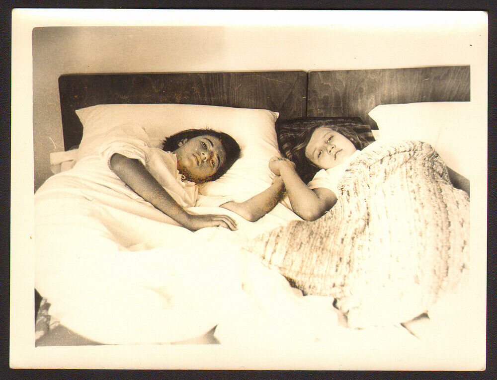 two young  girls holding  hands lying on bed   old photo 9x12cm #33737