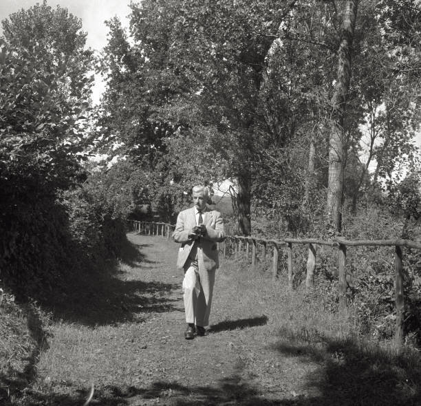 The American writer William Faulkner walking in a park 1950s Old Photo