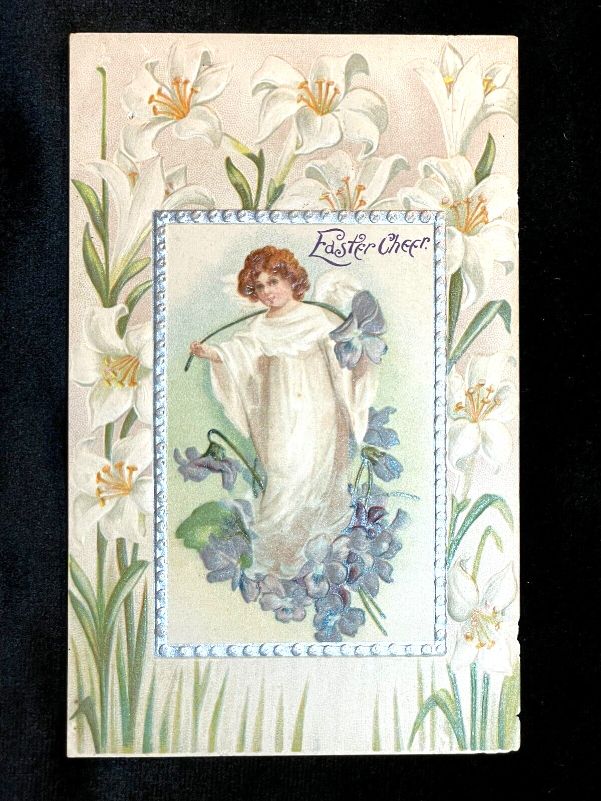 ANTIQUE EMBOSSED POSTCARD EASTER CHEER ANGEL WITH VIOLETS & LILIES SURROUNDING