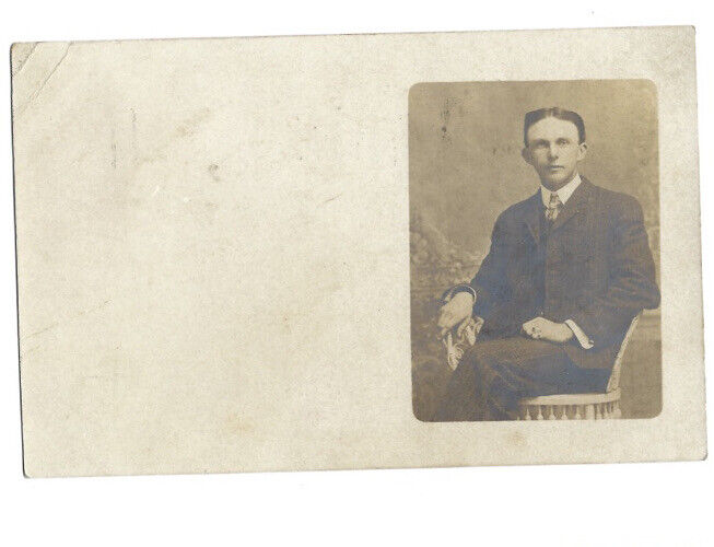 c.1900s Teenage Boy Sitting On White Chair RPPC Real Photo Postcard POSTED