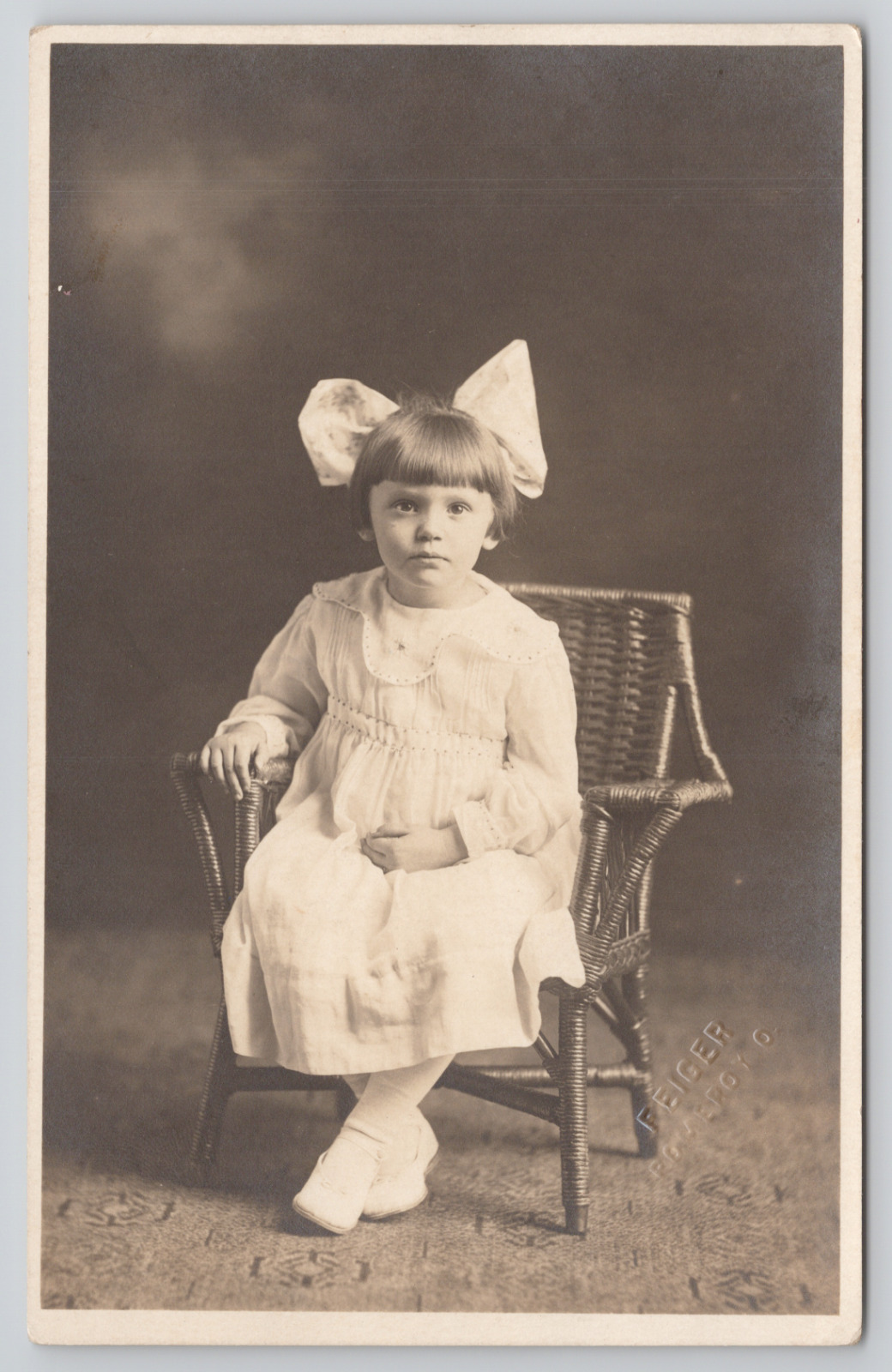 RPPC Little Girl In Studio White Dress Big Bow c1910 Real Photo Postcard