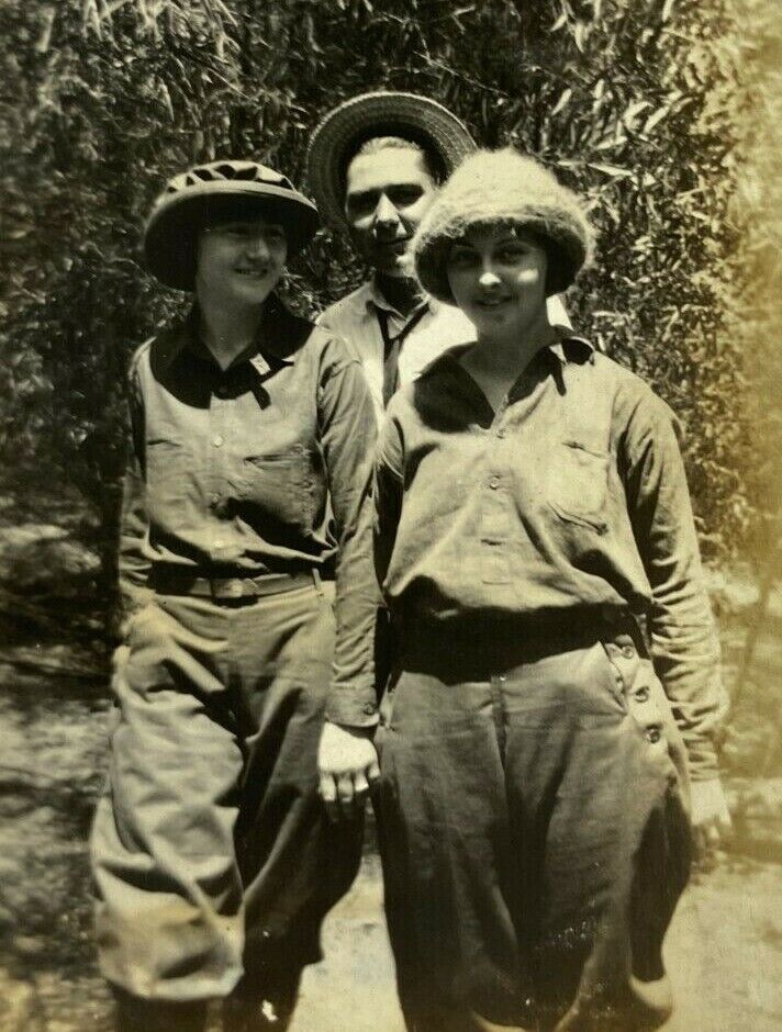 Two Women Standing With Man In Hat Behind B&W Photograph 2.75 x 4.5