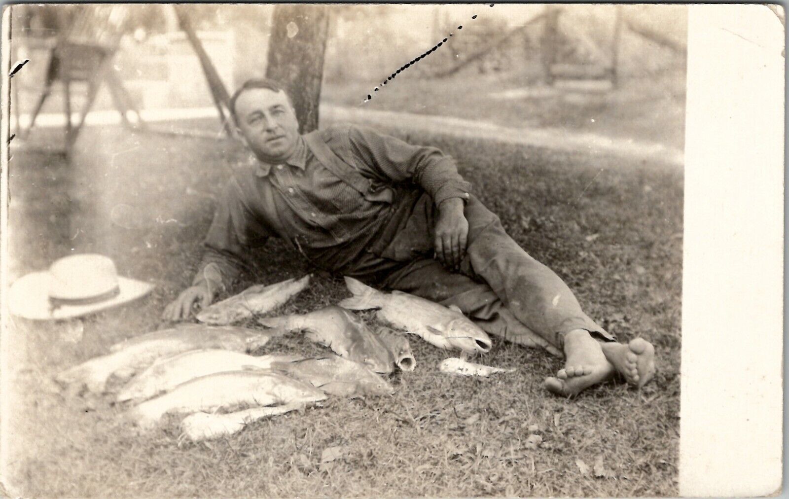 RPPC Barefoot Man Posing on Lawn with His Catch of Fish c1920s Postcard W4