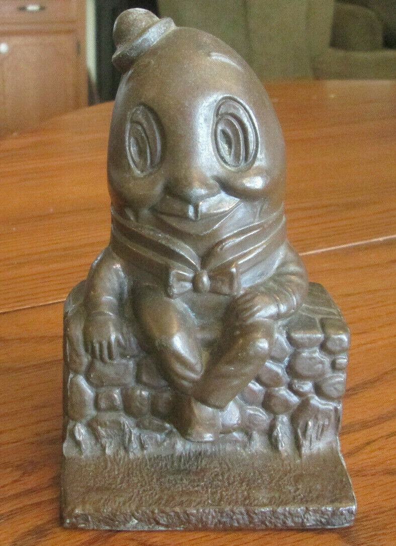 VINTAGE HUMPTY DUMPTY METAL COIN BANK. MISSING STOPPER