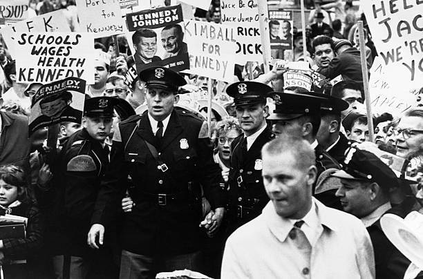 People holding signs while policemen control crowds Kennedy campaig- Old Photo