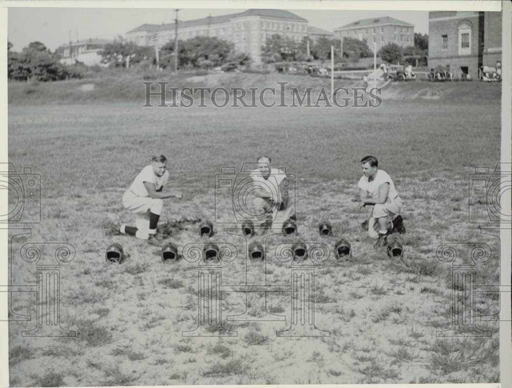 1936 Press Photo Coaches at Caroline State College view empty helmets on field
