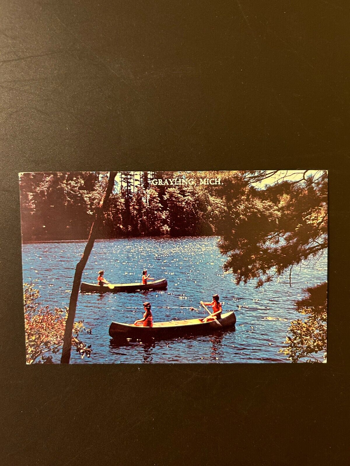 Grayling Michigan canoes on a lake postcard