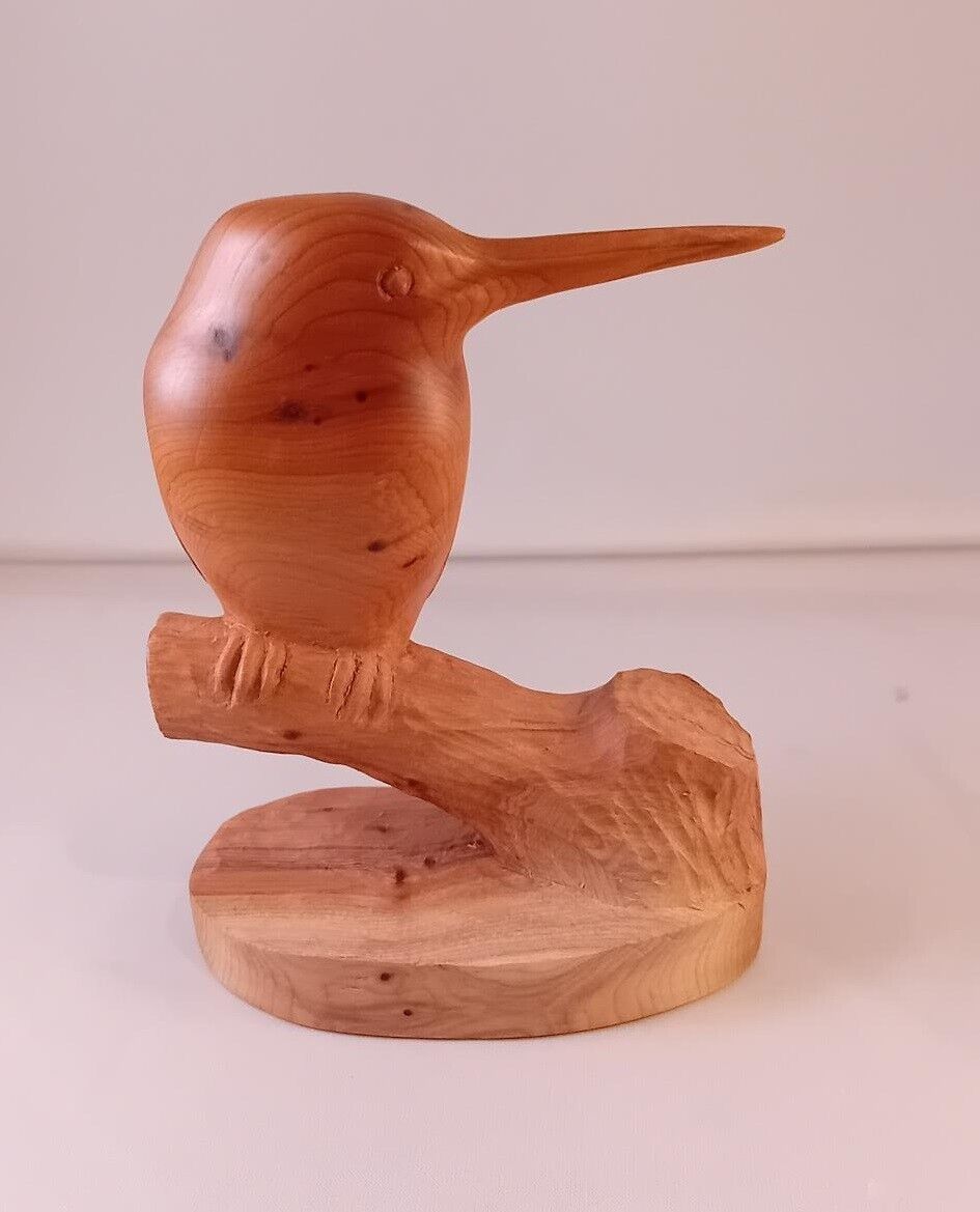 Kingfisher carved in Yew displayed on sitting on a tree stump