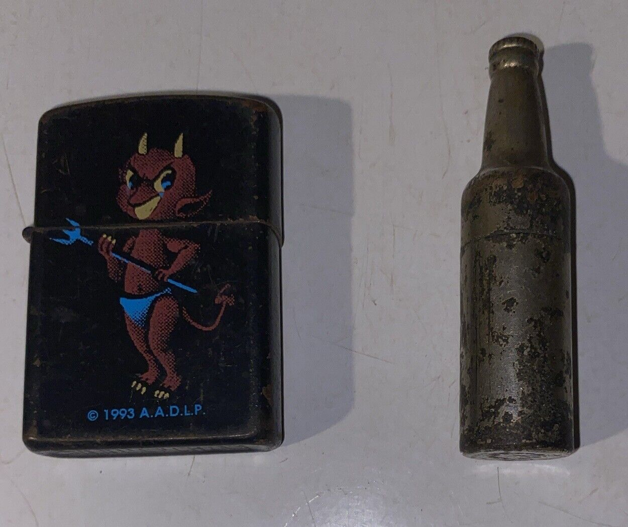 Vintage A.A.D.L.P Lighter 1994 Devil And KEM Inc Bottle Shape Lite. Not Tested