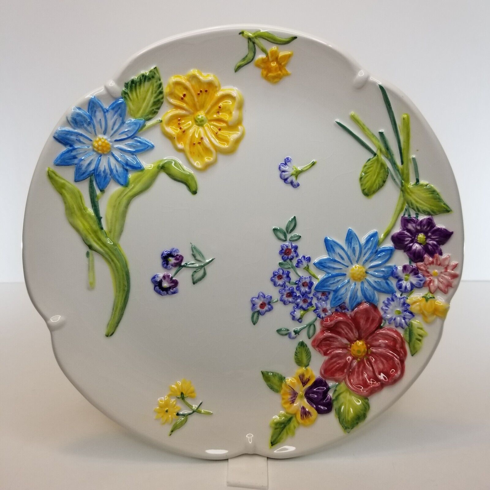 Round Plate with Raised Blue Yellow Red Flowers.