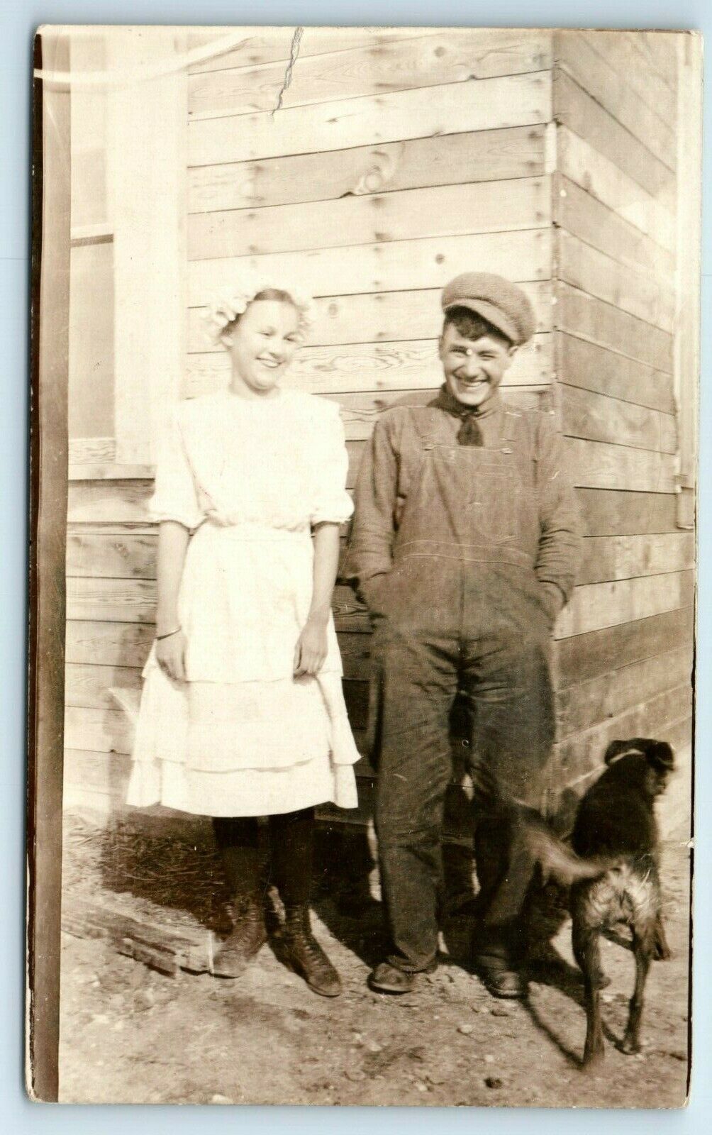 Postcard Happy Young Man & Woman outside Home w/ Dog, overalls, dress  RPPC B197