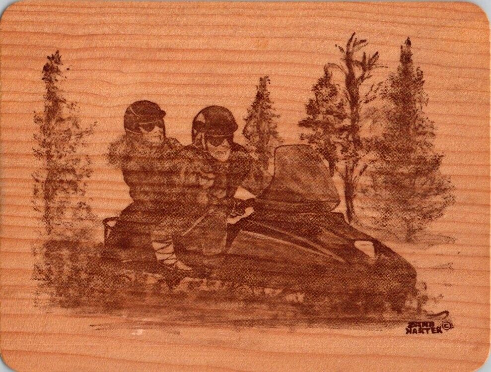 wooden postcard, unposted couple on a snowmobile