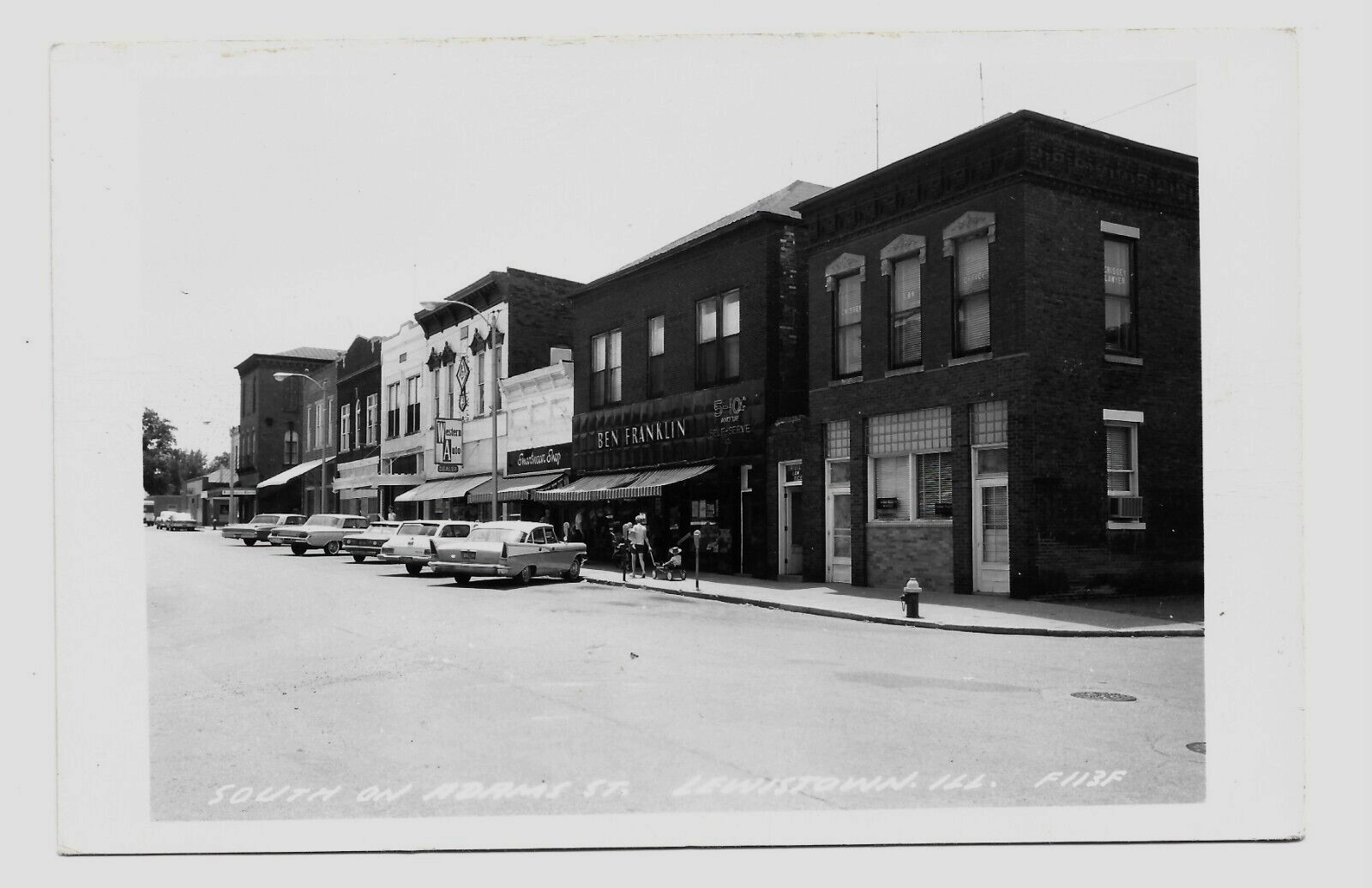 1950's LEWISTOWN, ILL.  RPPC POSTCARD SOUTH ON ABRAMS STREET