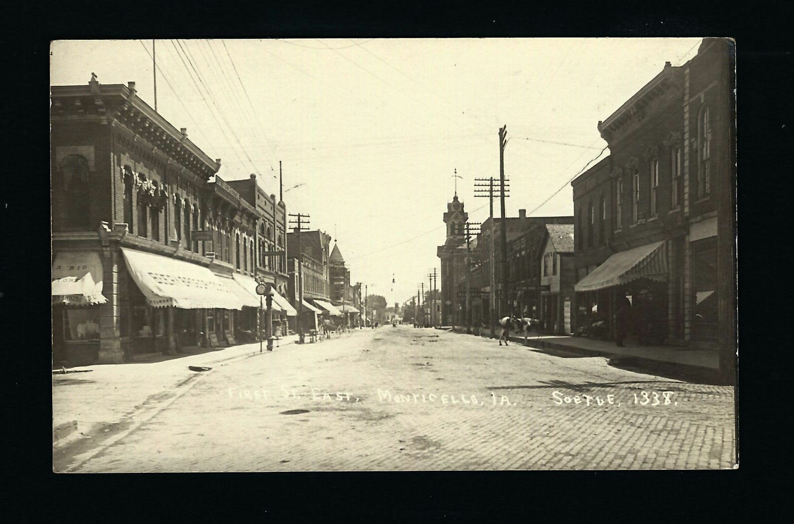 Monticello Iowa IA 1913 RPPC First Street East, Clothing, Hardware, Realty, MORE