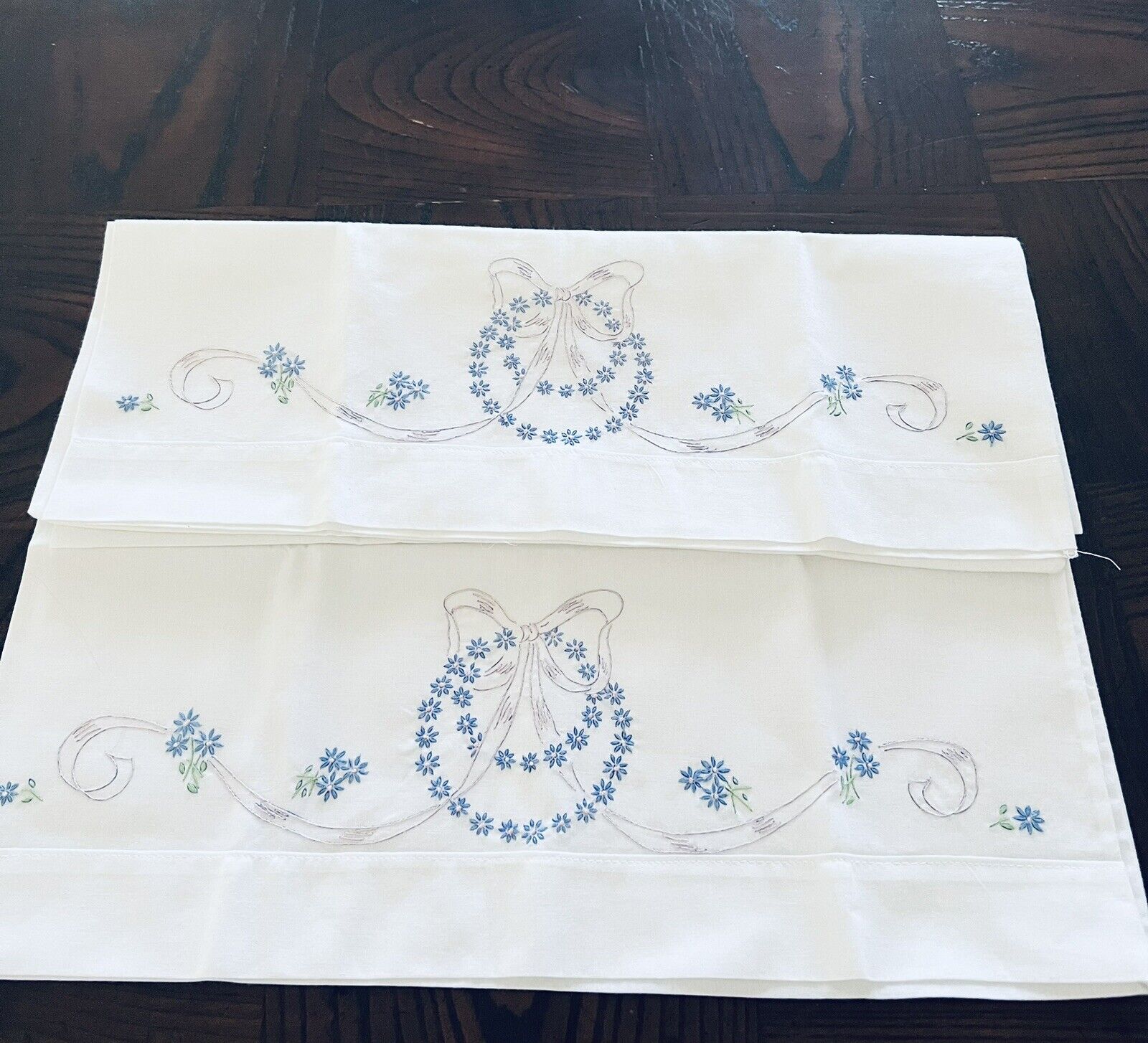 Hand embroidered pillowcases tiny blue flowers and lilac ribbon and bow Unused