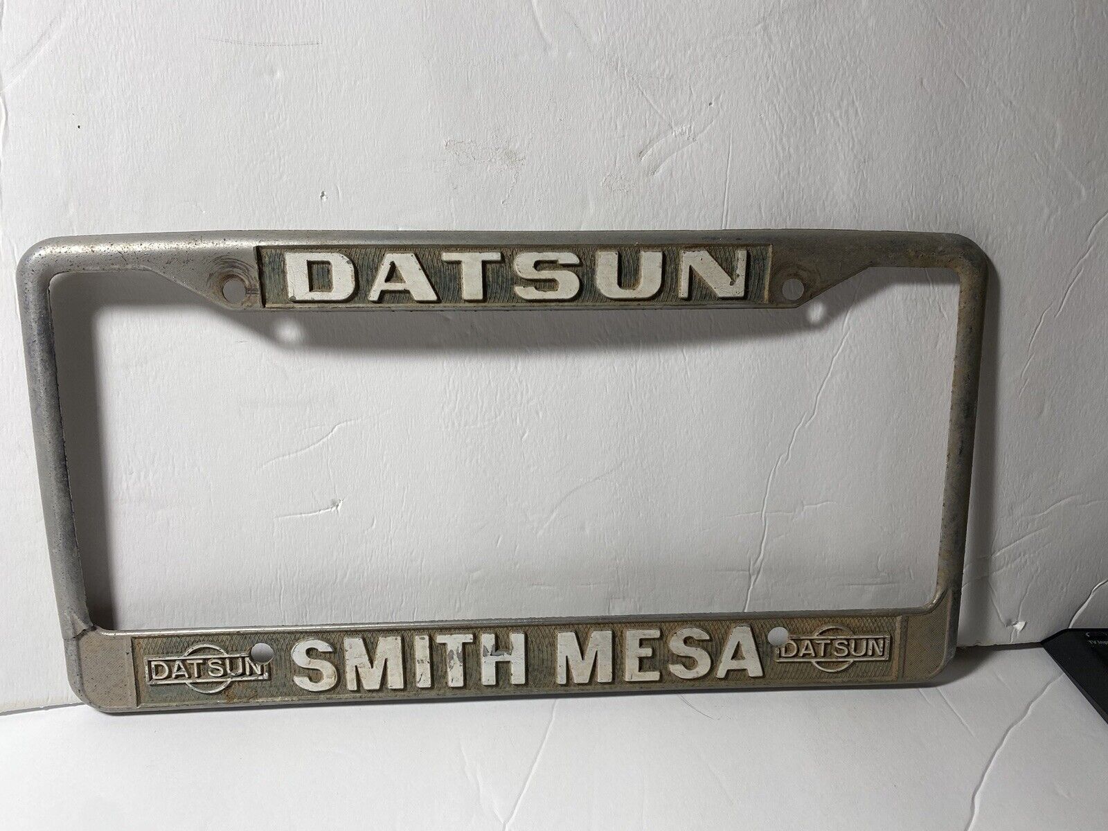 Vintage DATSUN Smith Mesa AZ Logo Metal License Plate Frame Original Broken