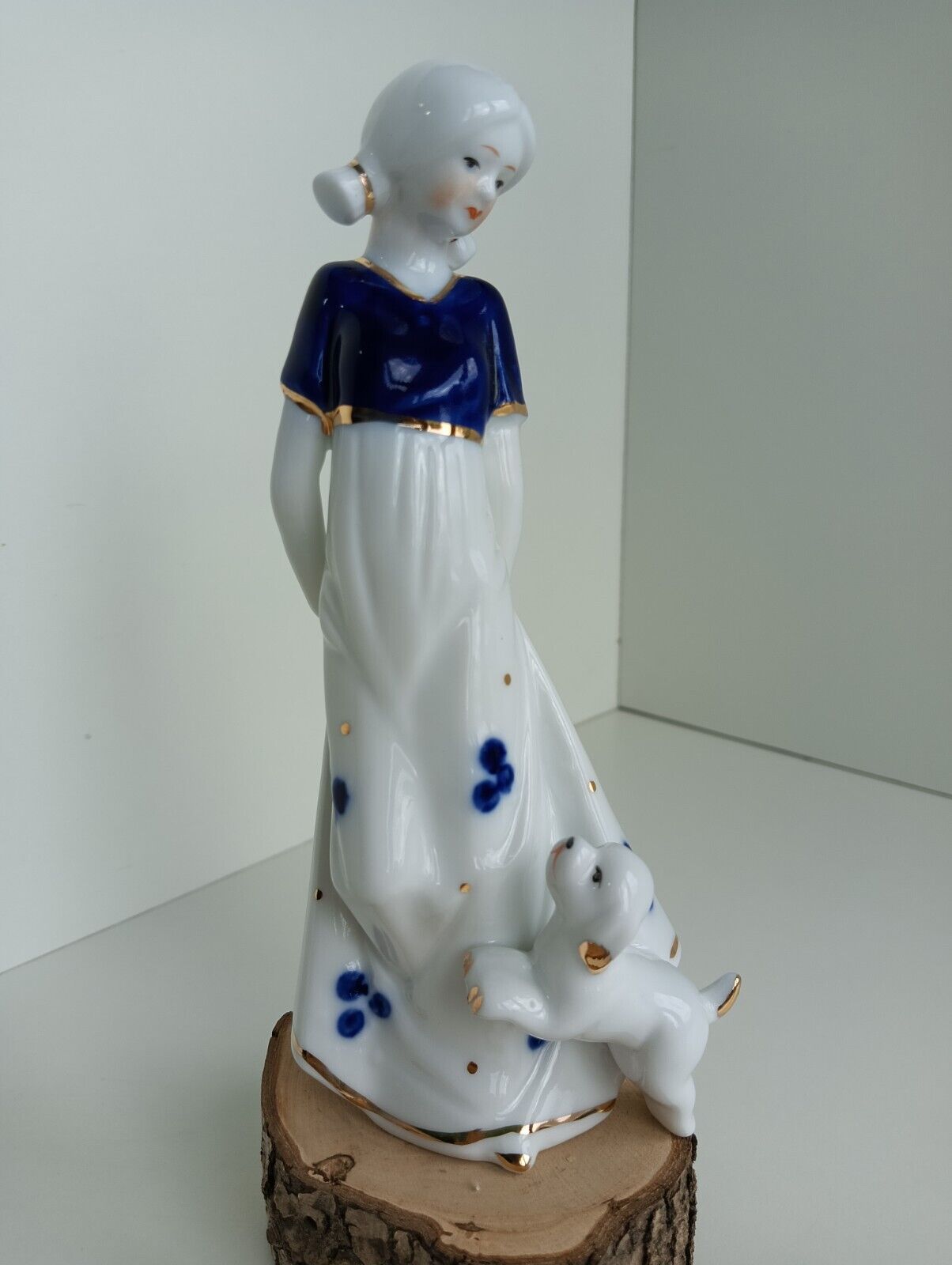 Porcelain figurine of a girl and a dog