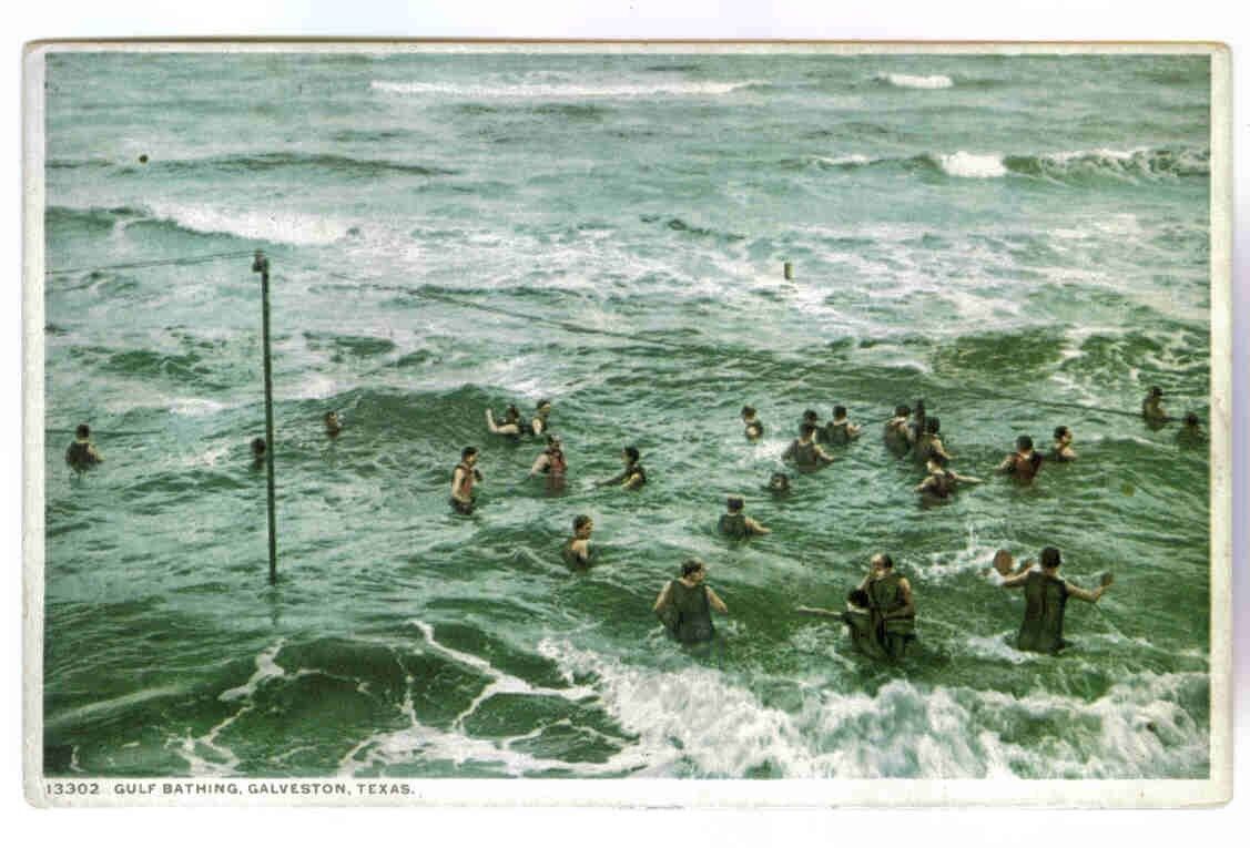 GULF BATHING GALVESTON,TEXAS, IN THE ROUGH SURF,1920-30'S VINTAGE POSTCARD