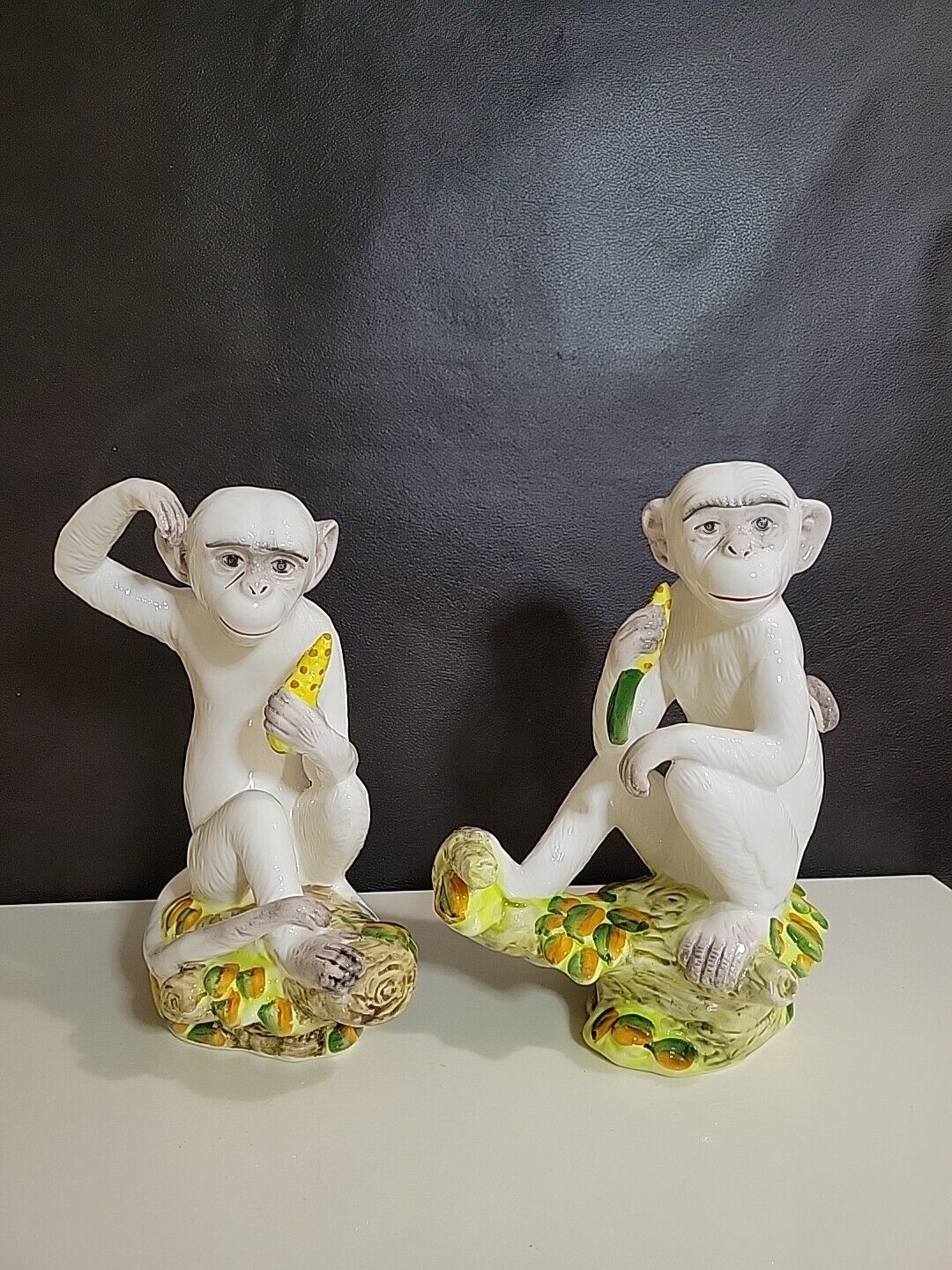 Pair of Hand Painted Ceramic Monkey Figurines .