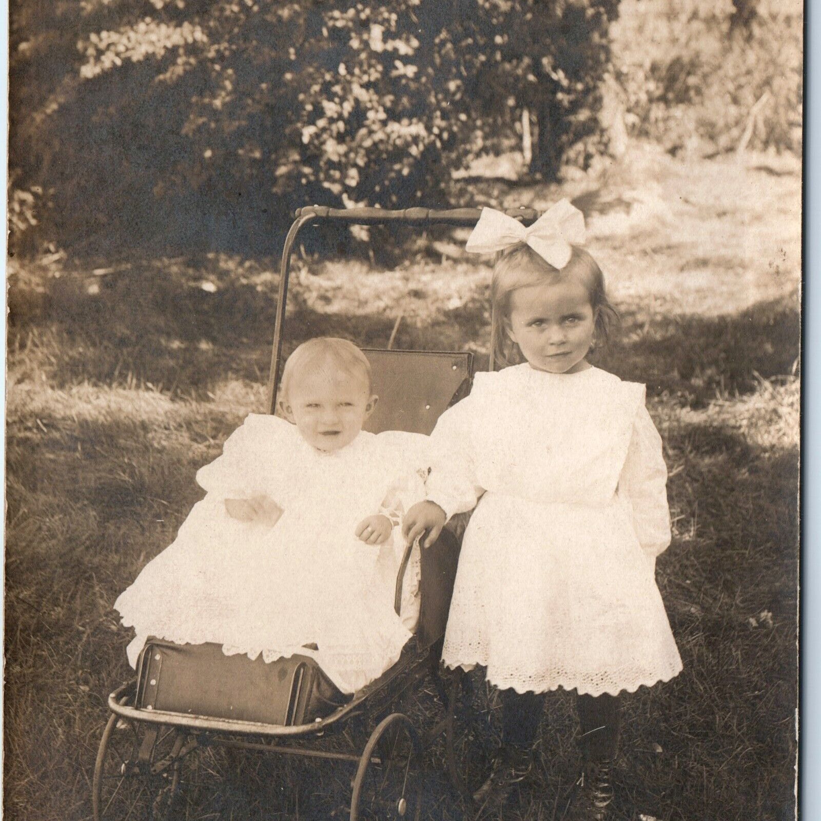 c1910s Adorable RPPC Little Girl w/ Baby Stroller Real Photo Cute Bow Laugh A171