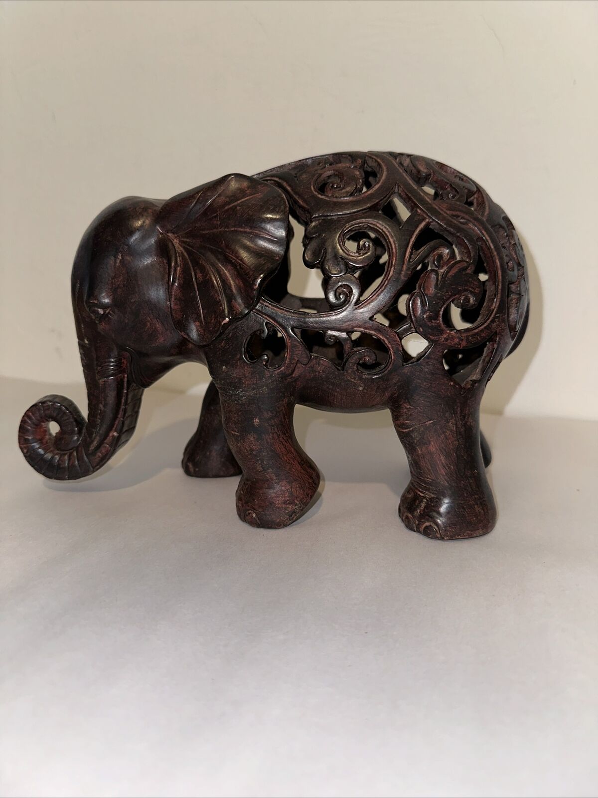 Decorative Carved Elephant Sculpture Open Work Dark Wood Tone Trunk Curved Up